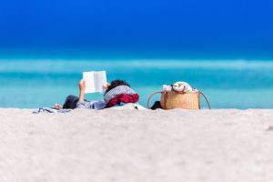 person reading at the beach