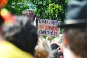 sign at Pride event reading "Queer Liberation Not Rainbow Capitalism"