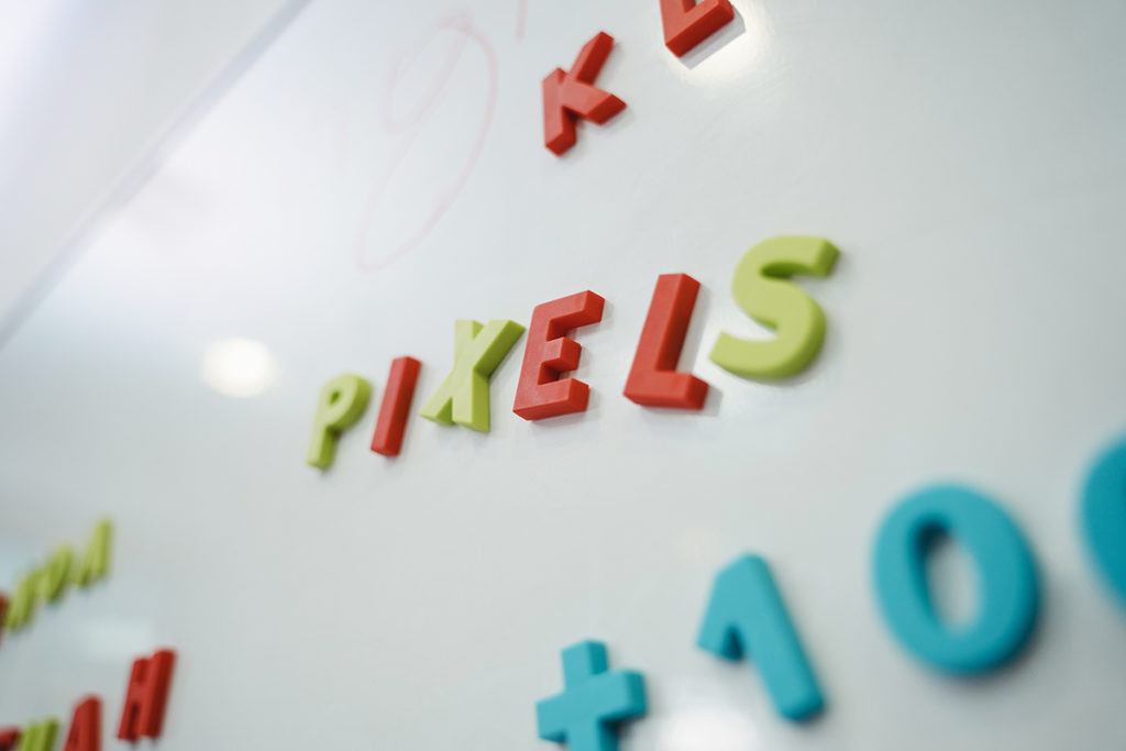 not quite a lead magnet--image of magnets on a whiteboard that spell the word Pixels